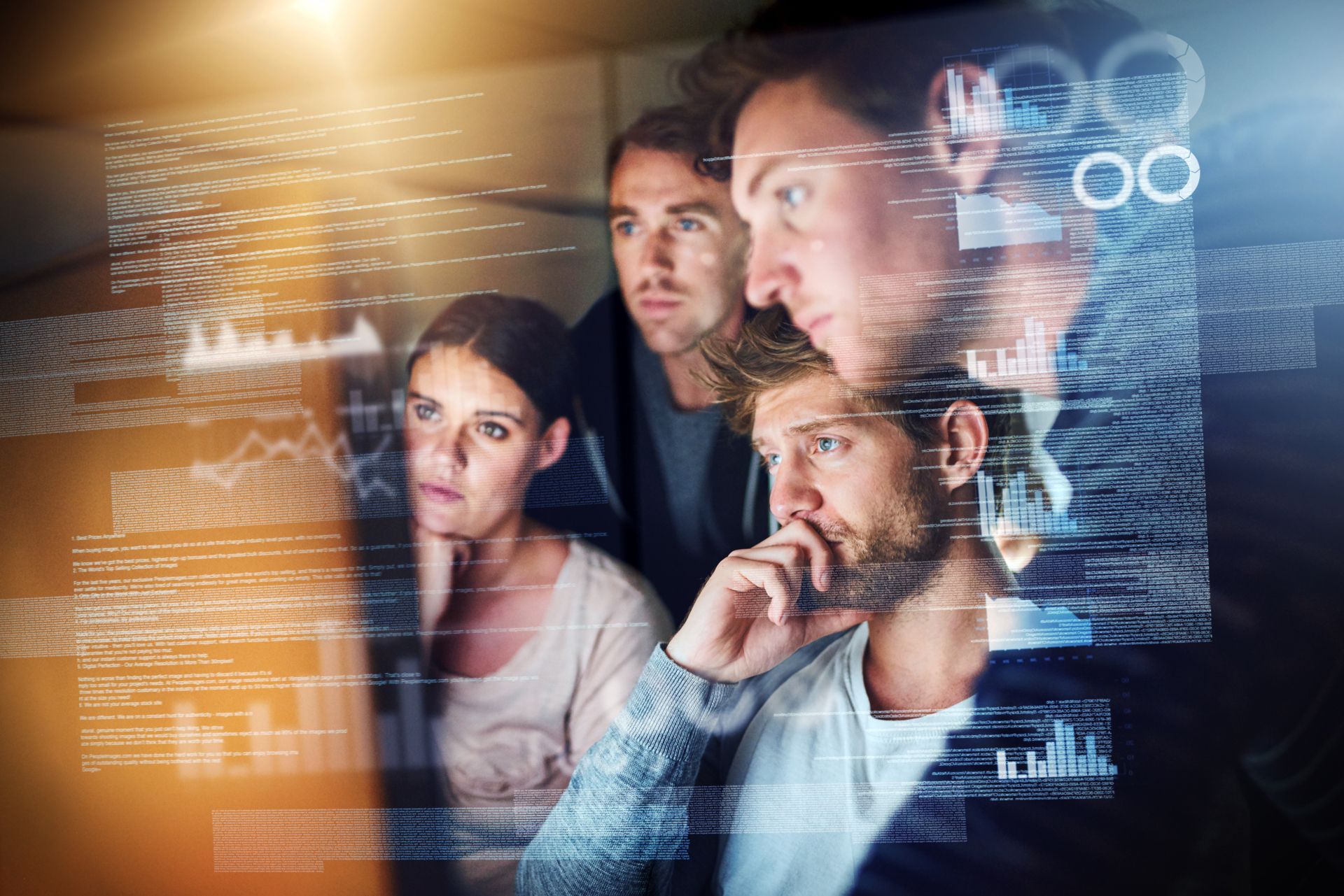 Group of employees looking together at a screen in the context of a CANCOM digital signage solution.