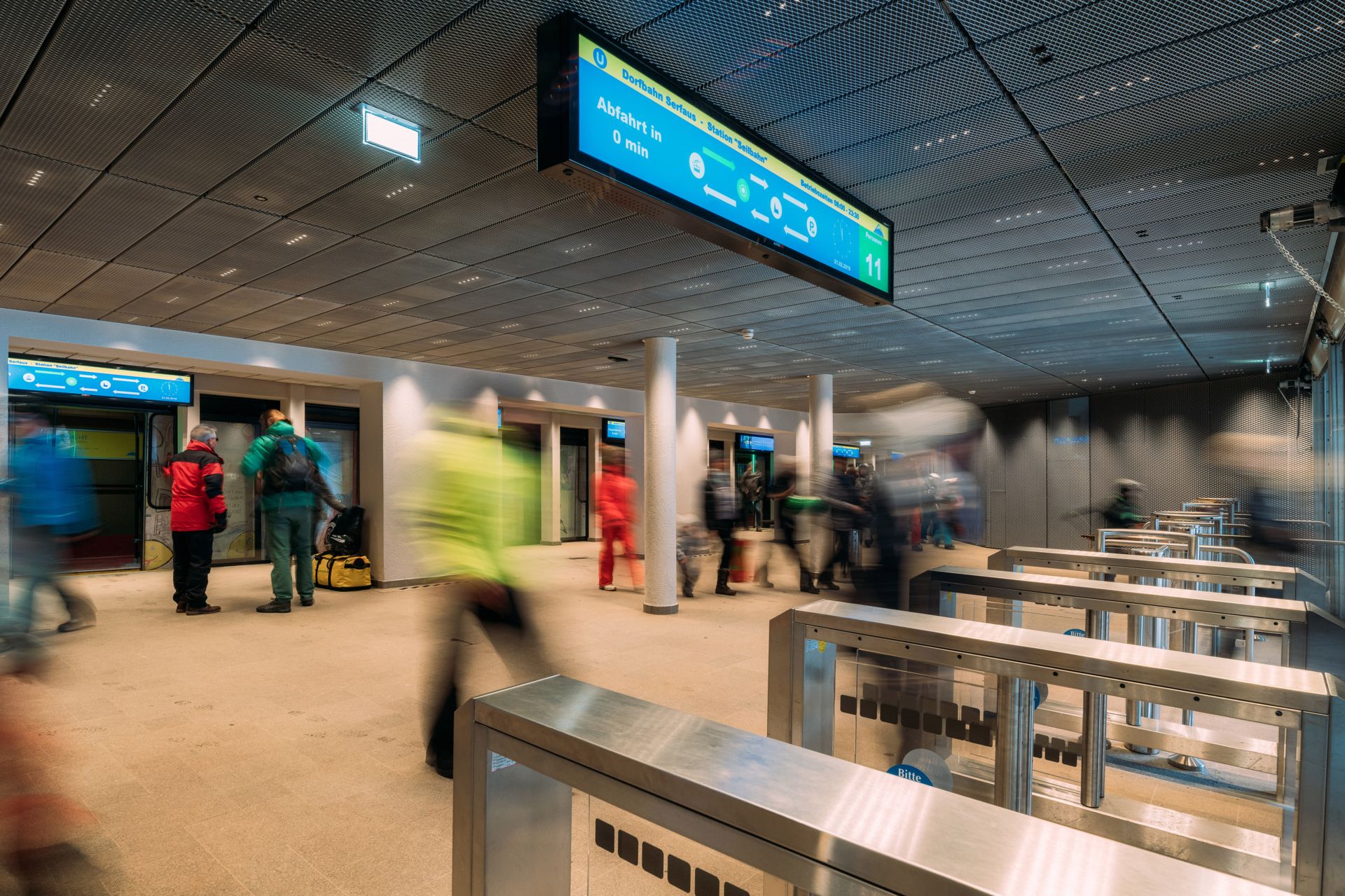 Group of people in an airport, surrounded by digital signage displays from CANCOM.