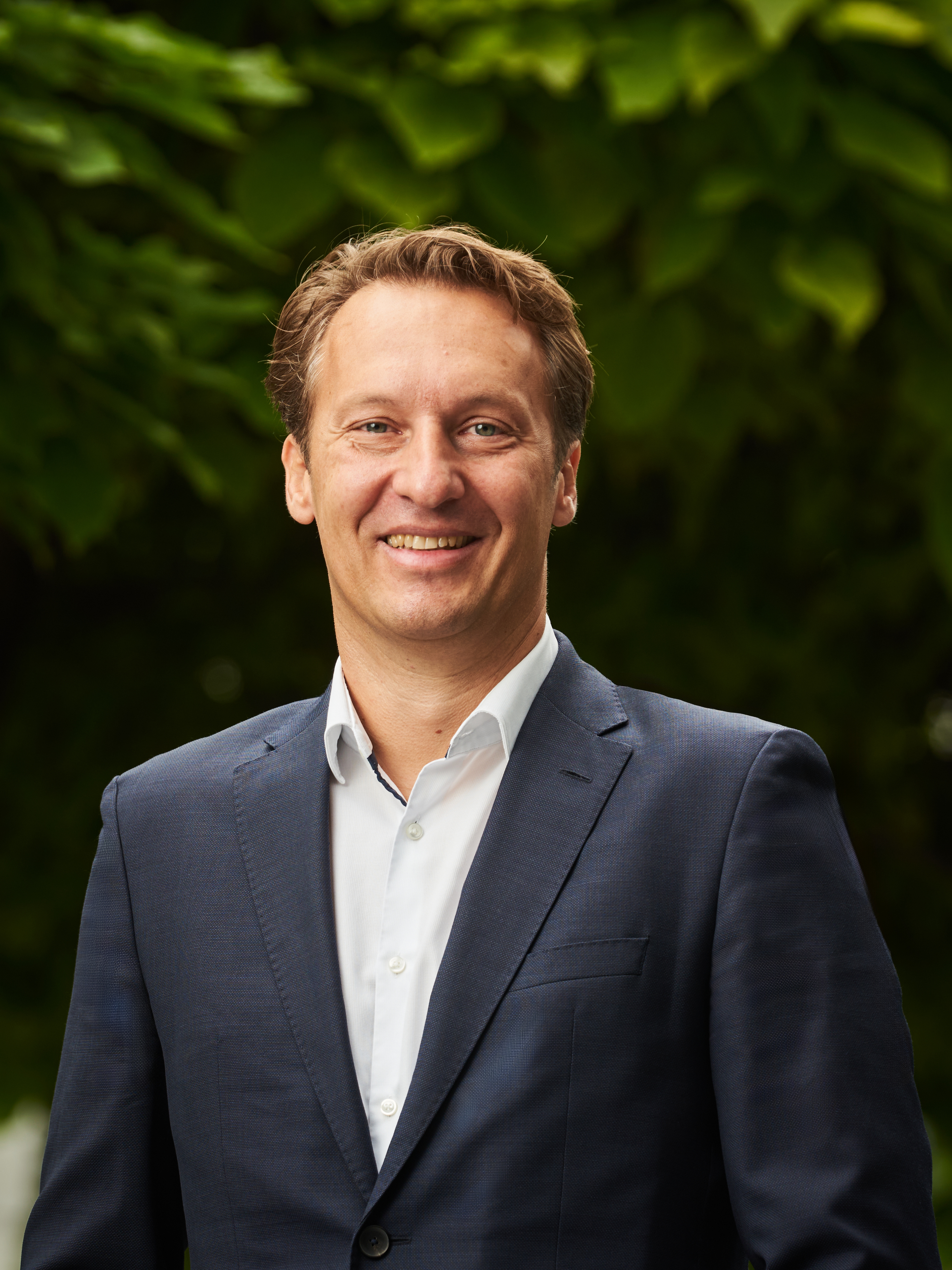 Martin Ellesch, Senior VP Managed Services at CANCOM, smiling in a suit.